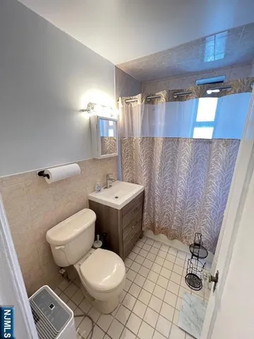 a bathroom with a sink mirror vanity and toilet