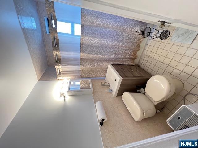 303 Hamilton Place, Unit D4 Hackensack, NJ 07601 - Photo 5 of 9 a bathroom with a sink mirror vanity and toilet