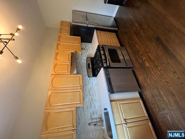 303 Hamilton Place, Unit D4 Hackensack, NJ 07601 - Photo 7 of 9 a kitchen with stainless steel appliances a sink cabinets and wooden floor