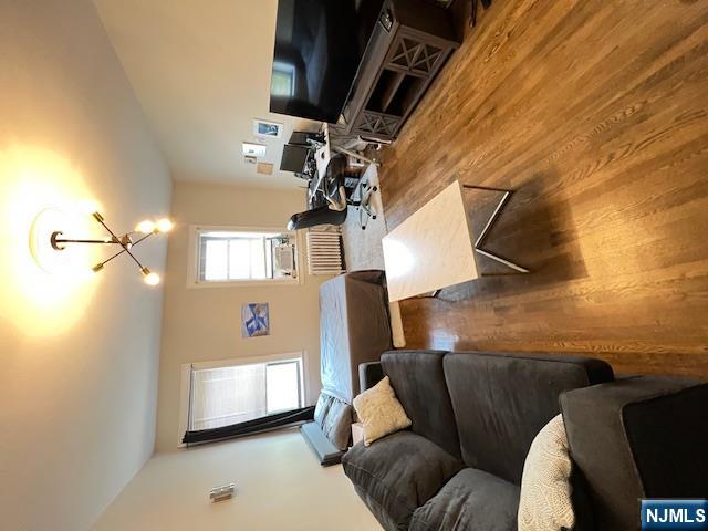 303 Hamilton Place, Unit D4 Hackensack, NJ 07601 - Photo 8 of 9 a living room with furniture and wooden floor