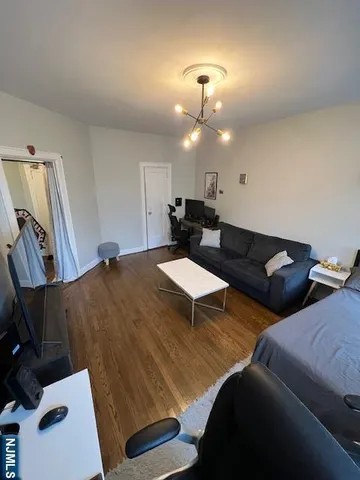 a living room with furniture and a lamp