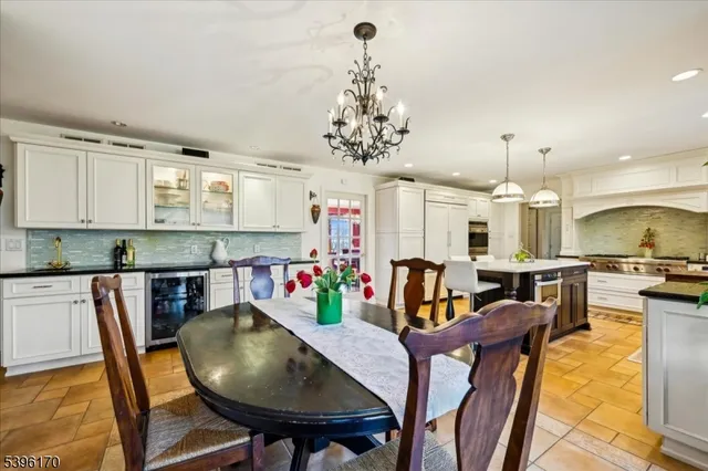 a view of a dining room with furniture and a chandelier