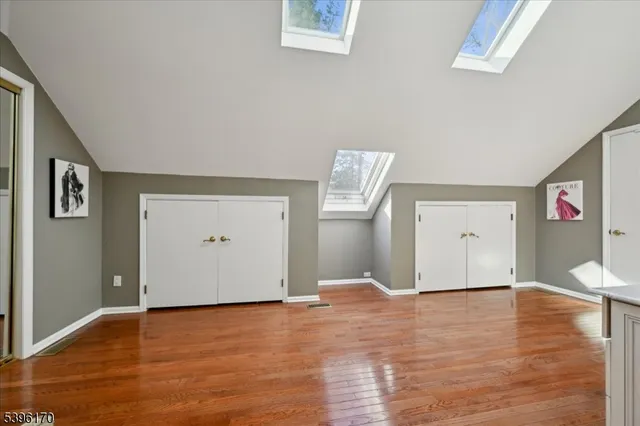 a view of a room with wooden floor