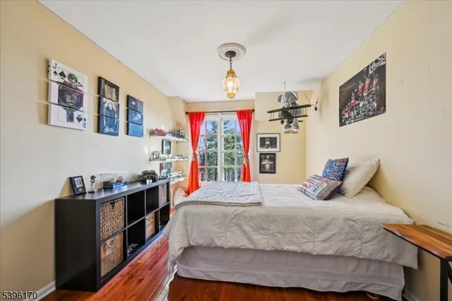 a bedroom with a bed dresser and window