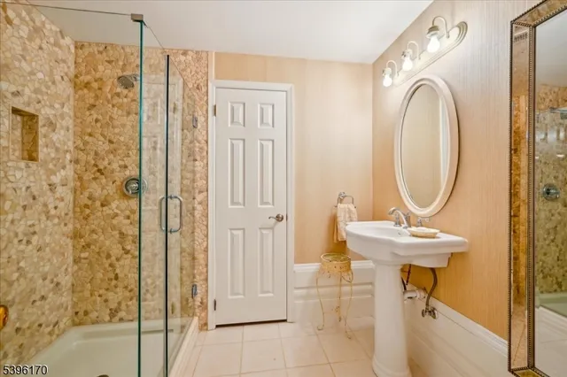 a bathroom with a sink a mirror and a shower