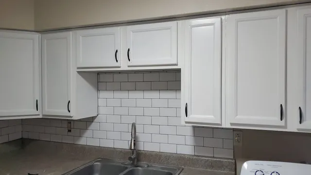 a bathroom with a sink and cabinets