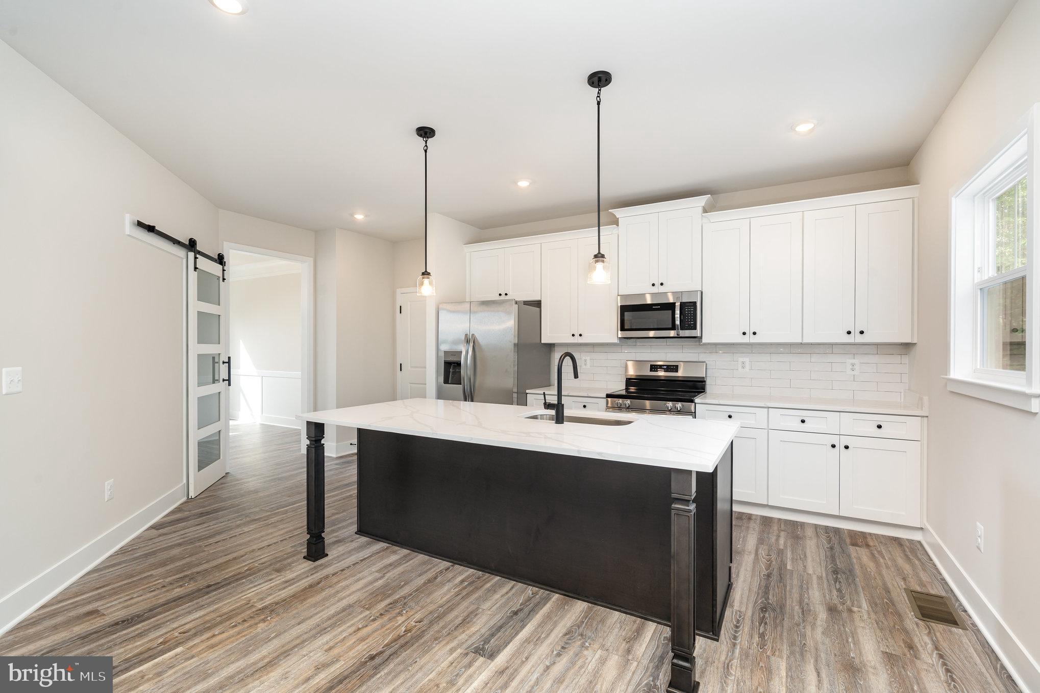 149 Norman Road Stafford, VA 22554 - Photo 23 of 57 a kitchen with stainless steel appliances granite countertop a sink a stove and a refrigerator