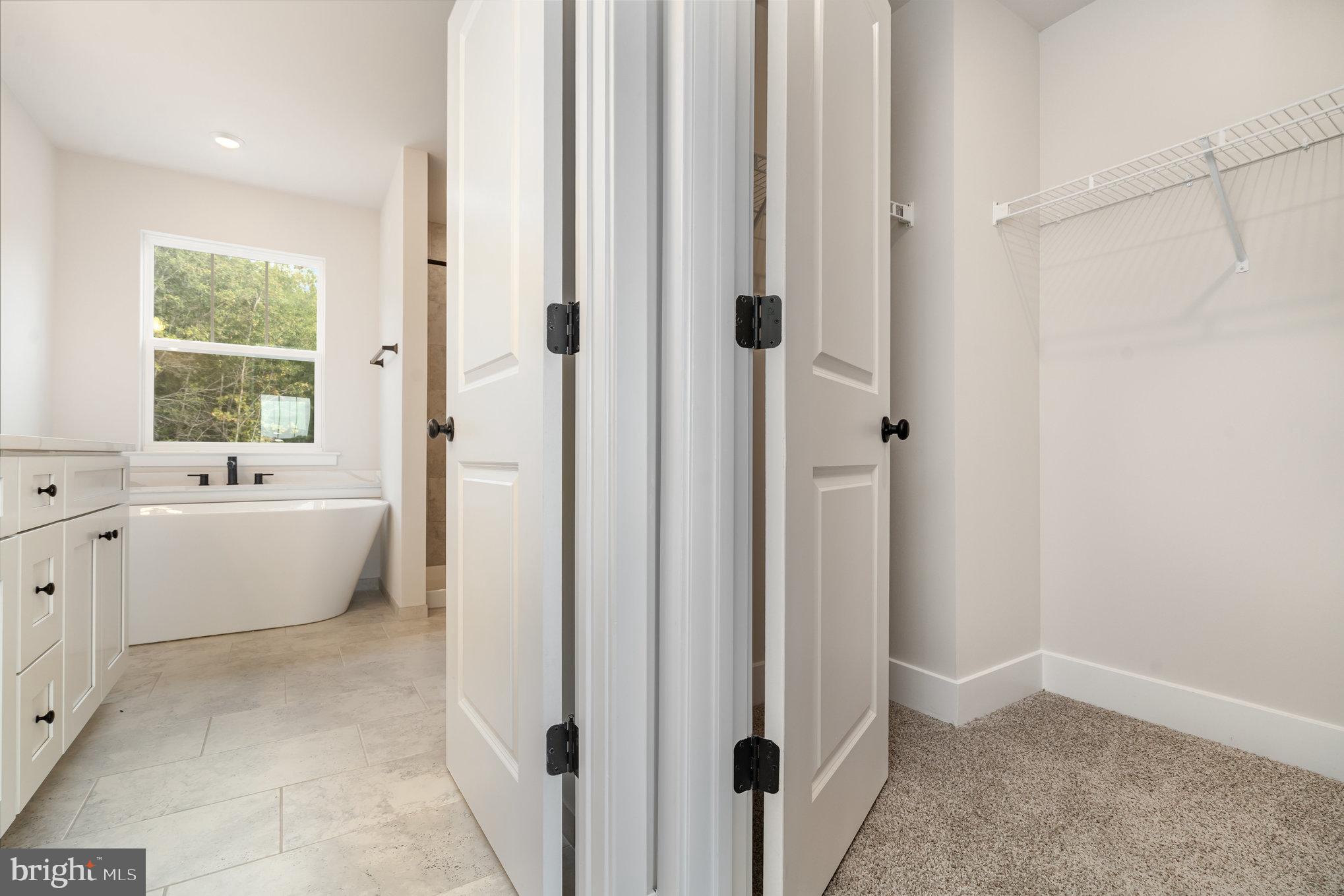 149 Norman Road Stafford, VA 22554 - Photo 33 of 57 a bathroom with a white tub shower and window