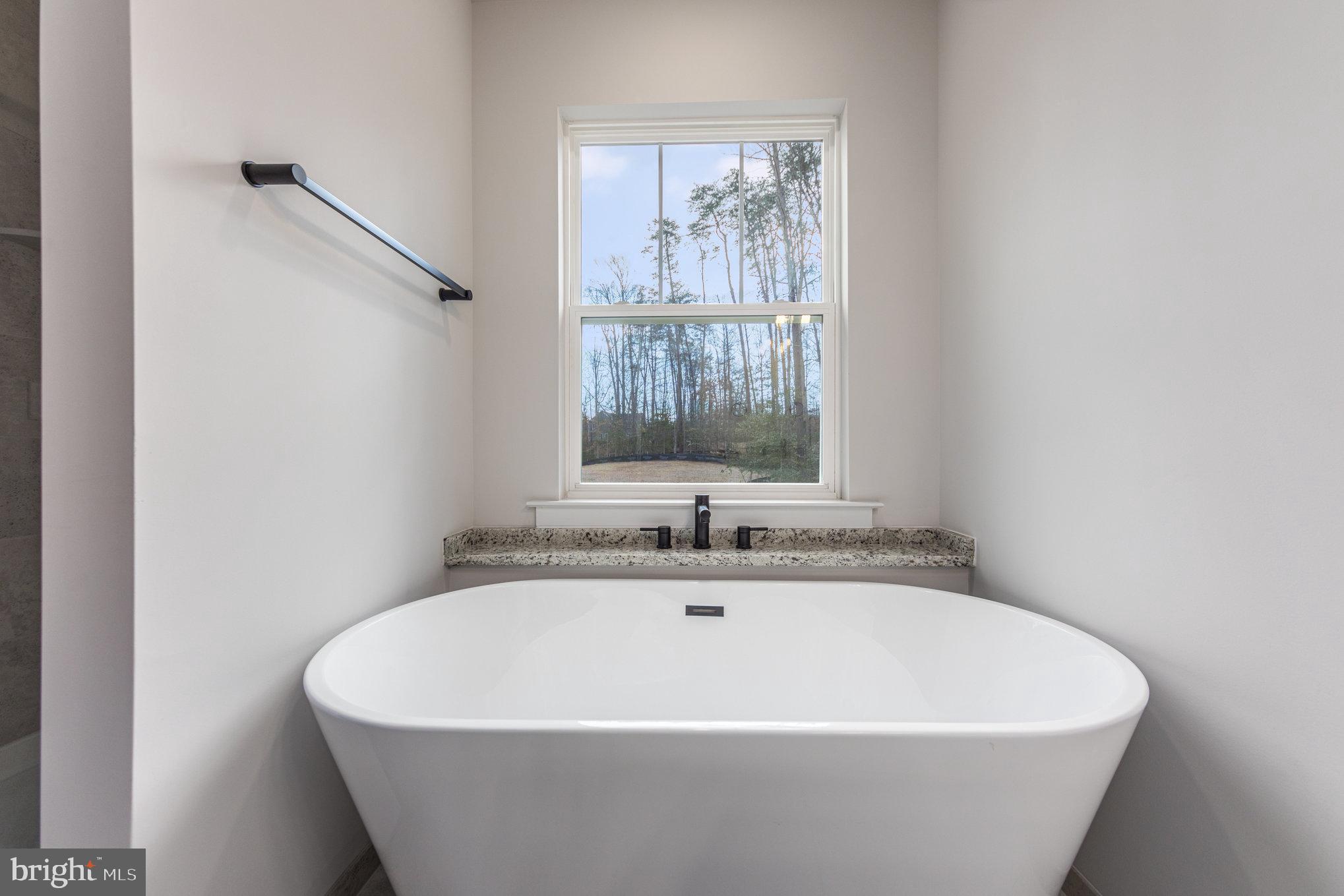 149 Norman Road Stafford, VA 22554 - Photo 36 of 57 a white bath tub sitting in a bathroom