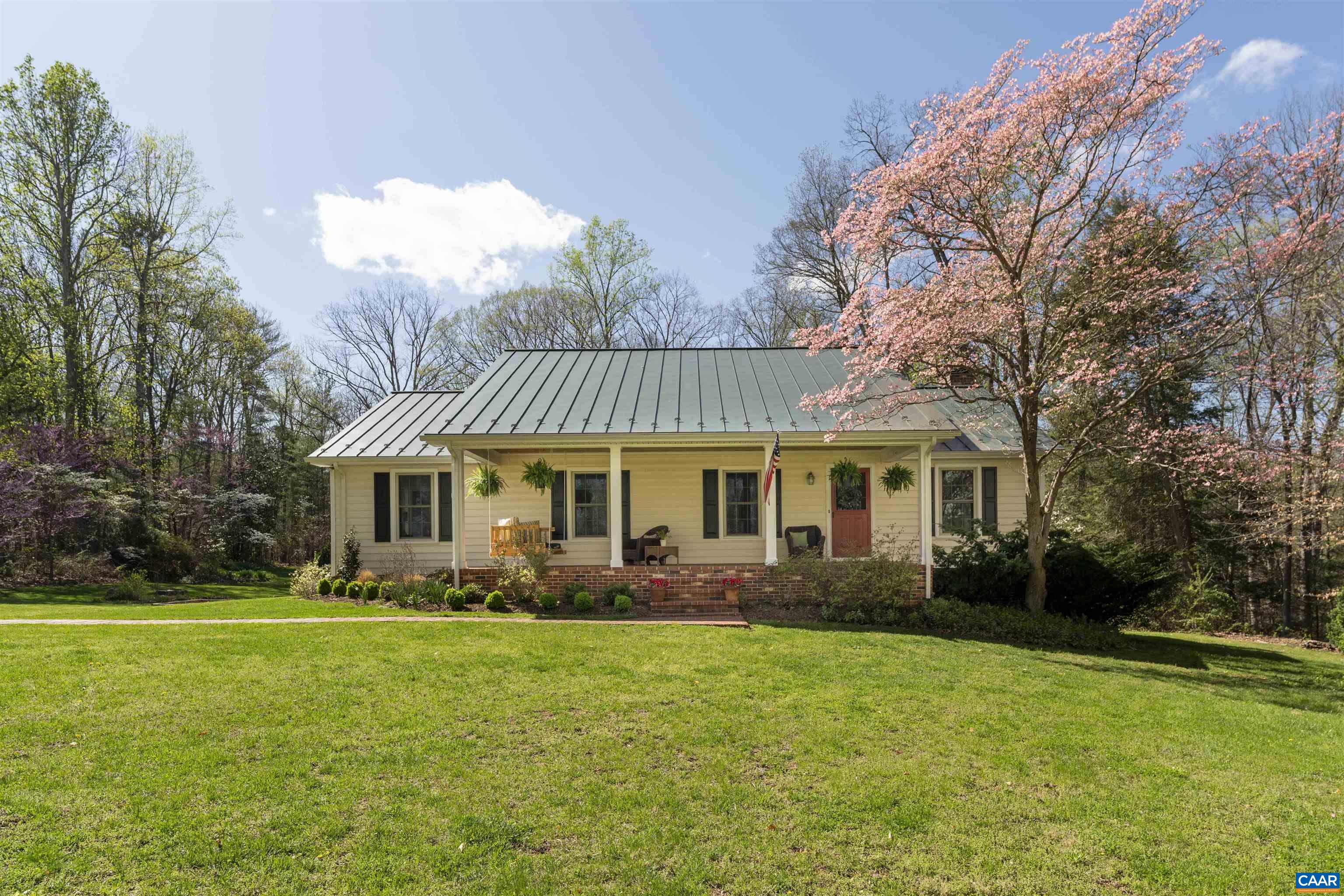 a front view of house with yard and green space