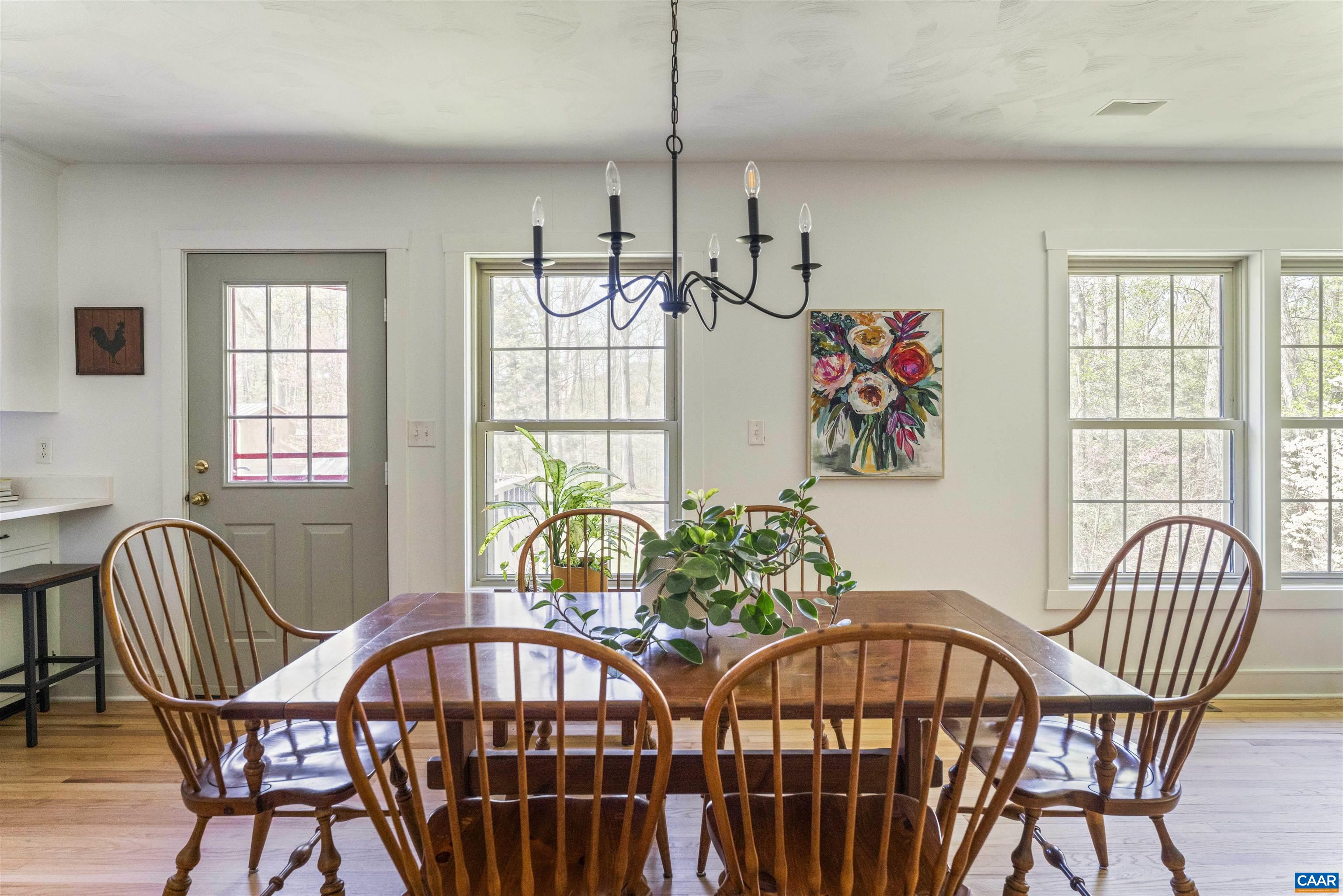 5138 Free Union Road Free Union, VA 22940 - Photo 12 of 55 a view of a dining room with furniture a livingroom and chandelier