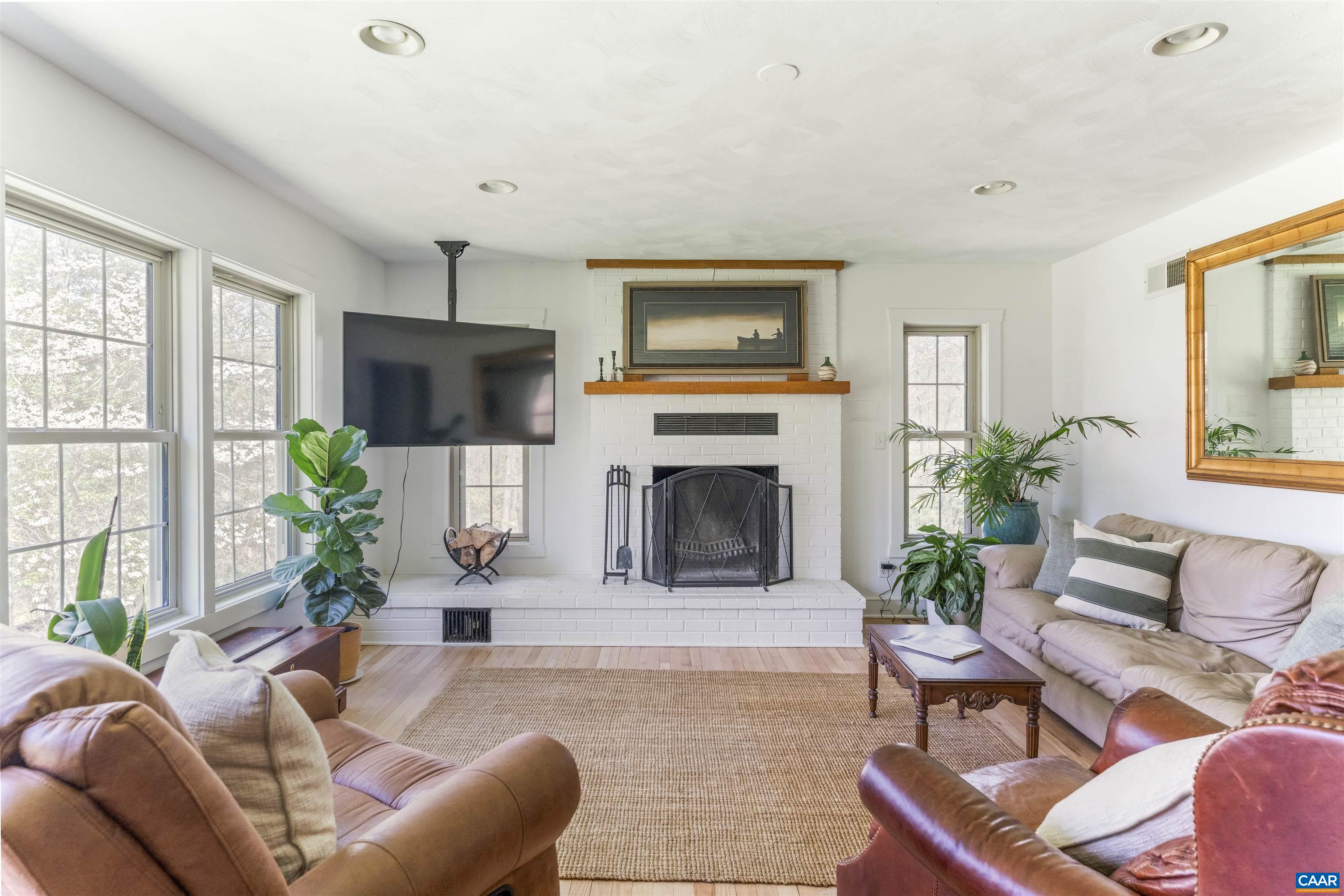 5138 Free Union Road Free Union, VA 22940 - Photo 8 of 55 a living room with furniture a potted plant and a fireplace