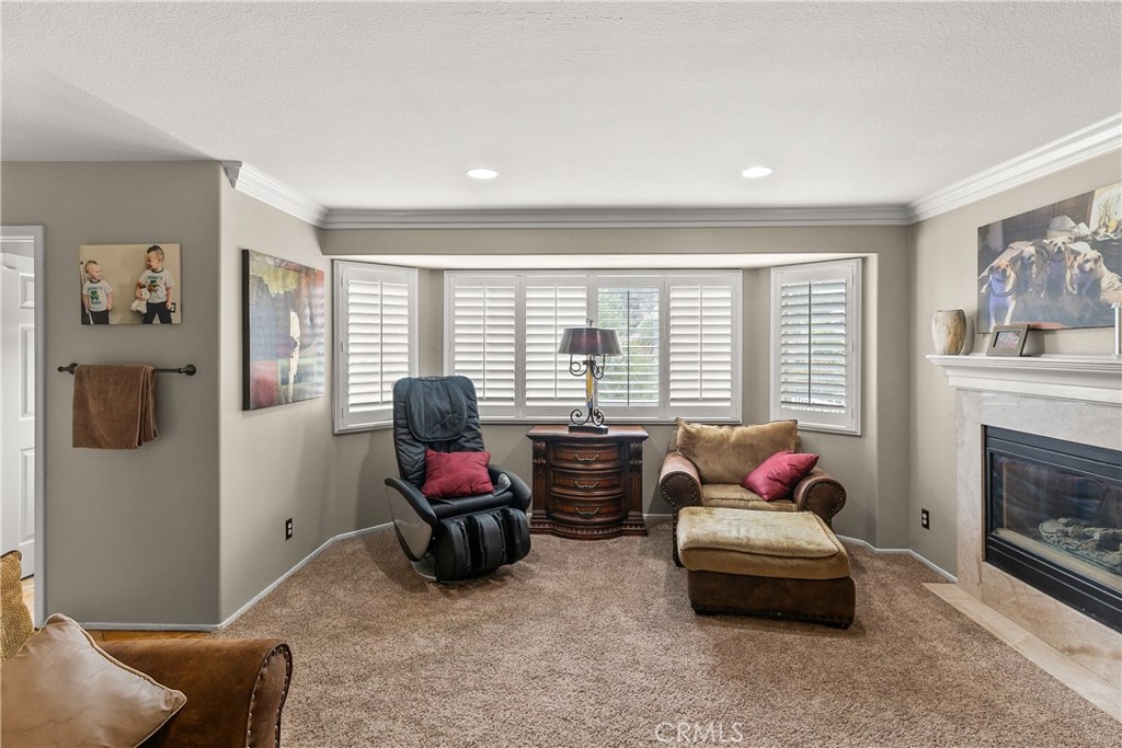 26266 Beecher Lane Stevenson Ranch, CA 91381 - Photo 14 of 25 a living room with furniture and a fireplace