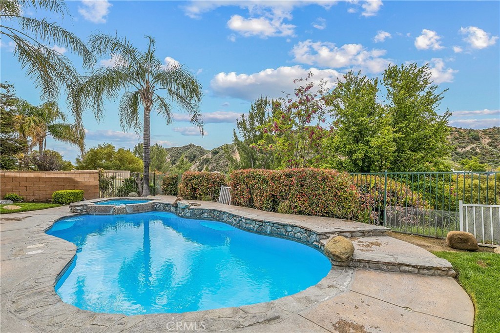 26266 Beecher Lane Stevenson Ranch, CA 91381 - Photo 21 of 25 a view of a swimming pool with a yard