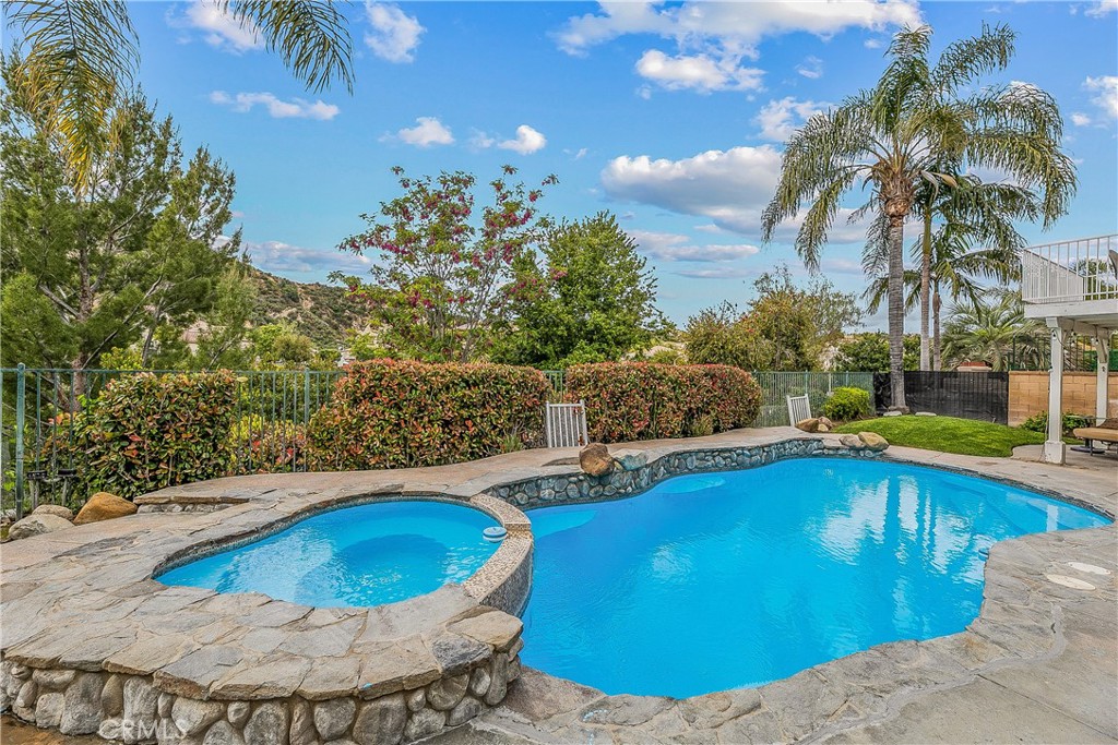 26266 Beecher Lane Stevenson Ranch, CA 91381 - Photo 22 of 25 a view of a swimming pool with a yard
