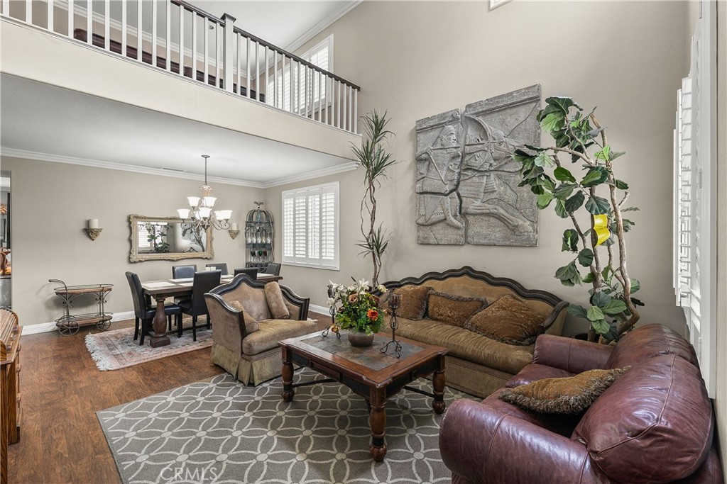 26266 Beecher Lane Stevenson Ranch, CA 91381 - Photo 4 of 25 a living room with furniture a chandelier and a dining table