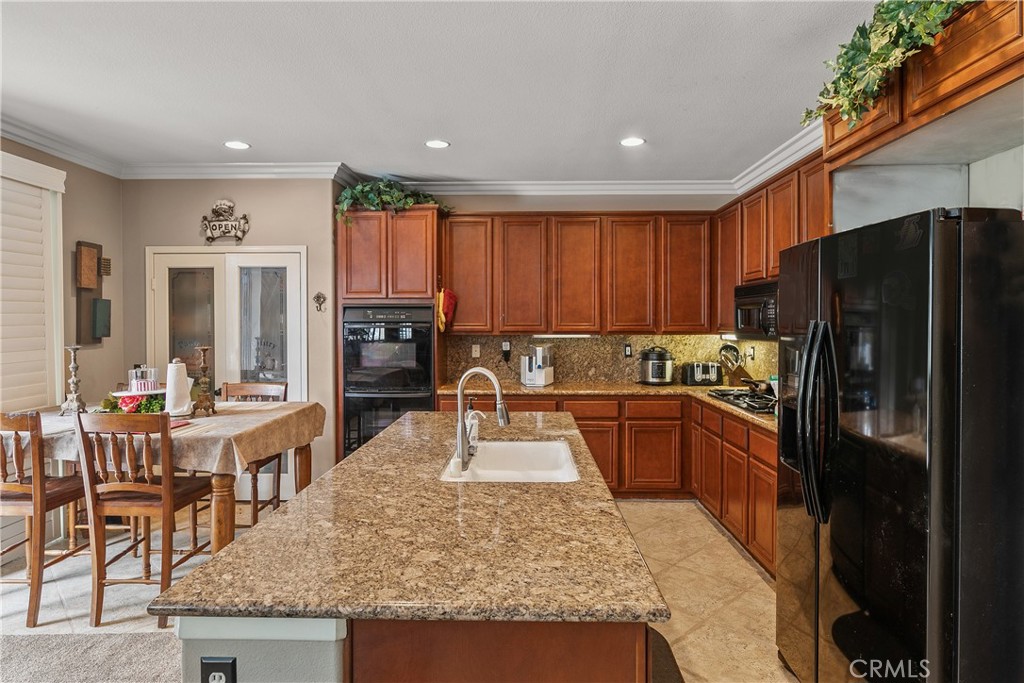 26266 Beecher Lane Stevenson Ranch, CA 91381 - Photo 8 of 25 a kitchen with stainless steel appliances granite countertop a refrigerator stove microwave and sink