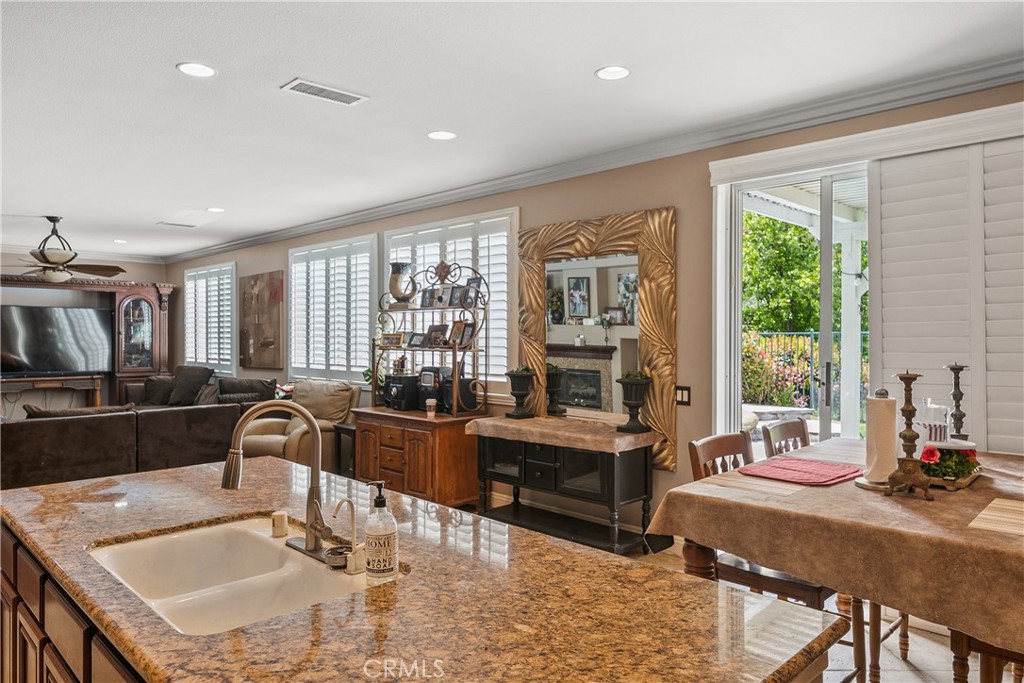 26266 Beecher Lane Stevenson Ranch, CA 91381 - Photo 9 of 25 a kitchen with granite countertop a sink and a stove