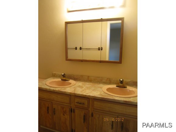 912 Forest Hylands Road, Unit 1 Prescott, AZ 86303 - Photo 5 of 10 a bathroom with a sink and a mirror