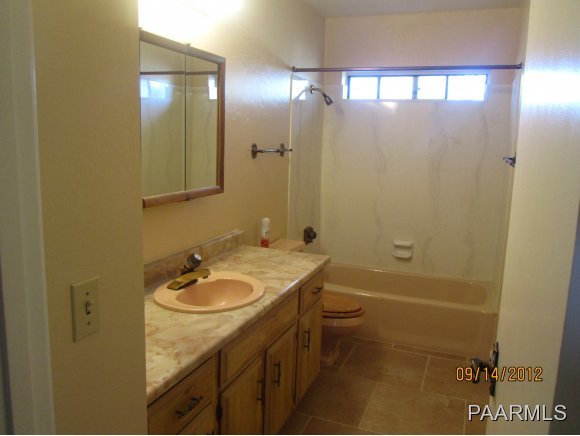 912 Forest Hylands Road, Unit 1 Prescott, AZ 86303 - Photo 10 of 10 a bathroom with a granite countertop sink toilet and shower