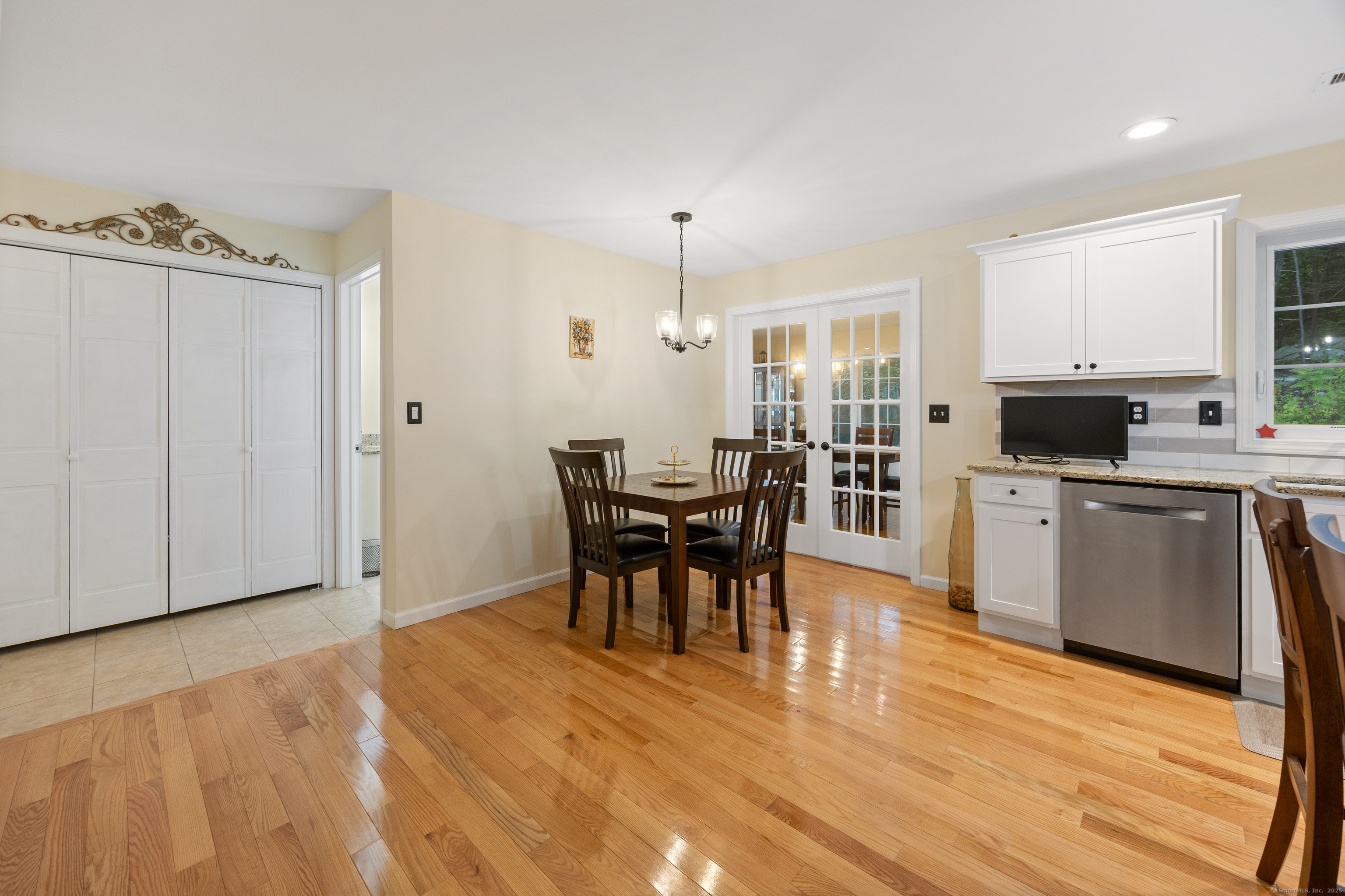 29 Hannah Way Harwinton, CT 06791 - Photo 12 of 34 a kitchen with stainless steel appliances a dining table chairs and granite counter tops