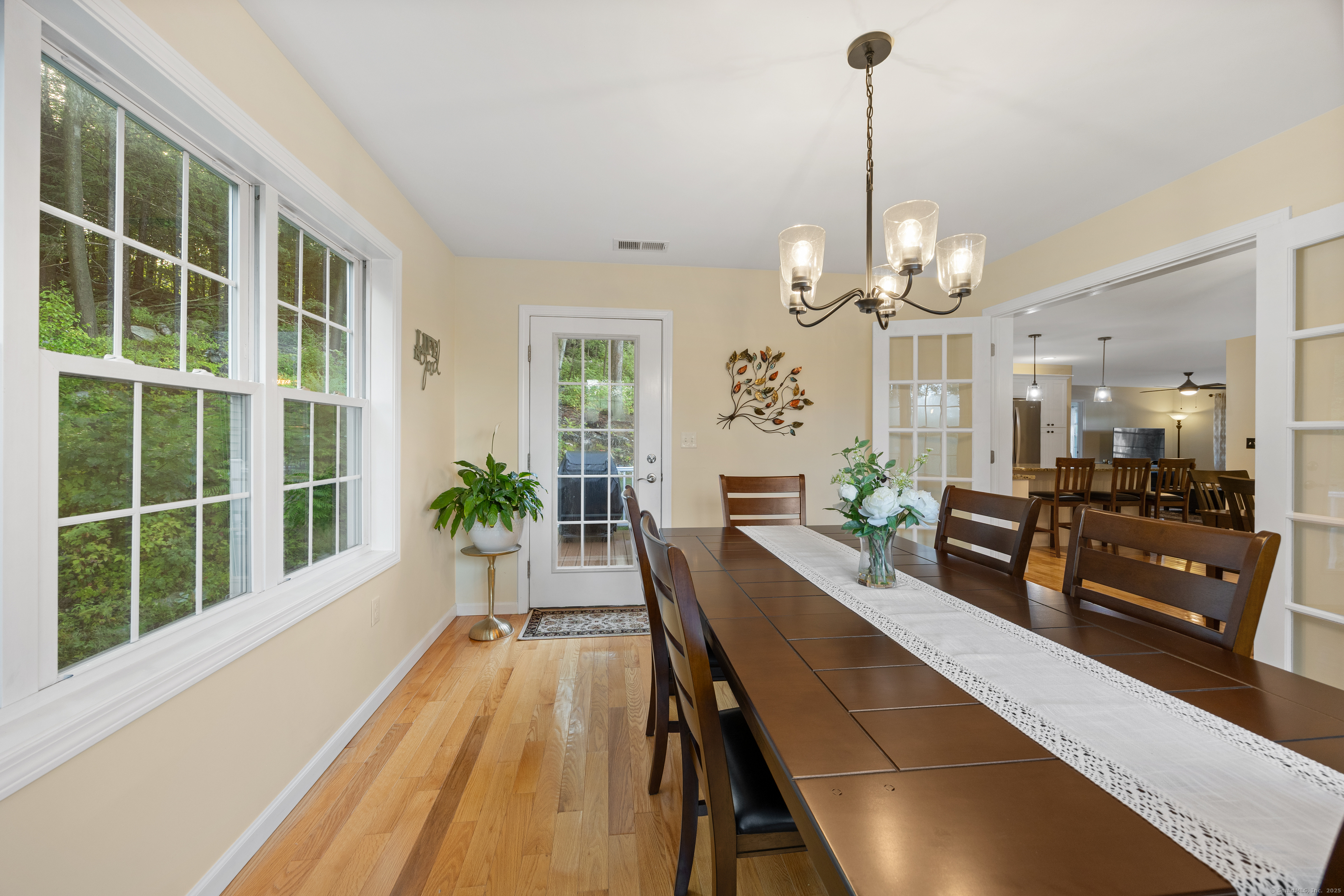 29 Hannah Way Harwinton, CT 06791 - Photo 15 of 34 a view of a dining room with furniture a chandelier and large windows