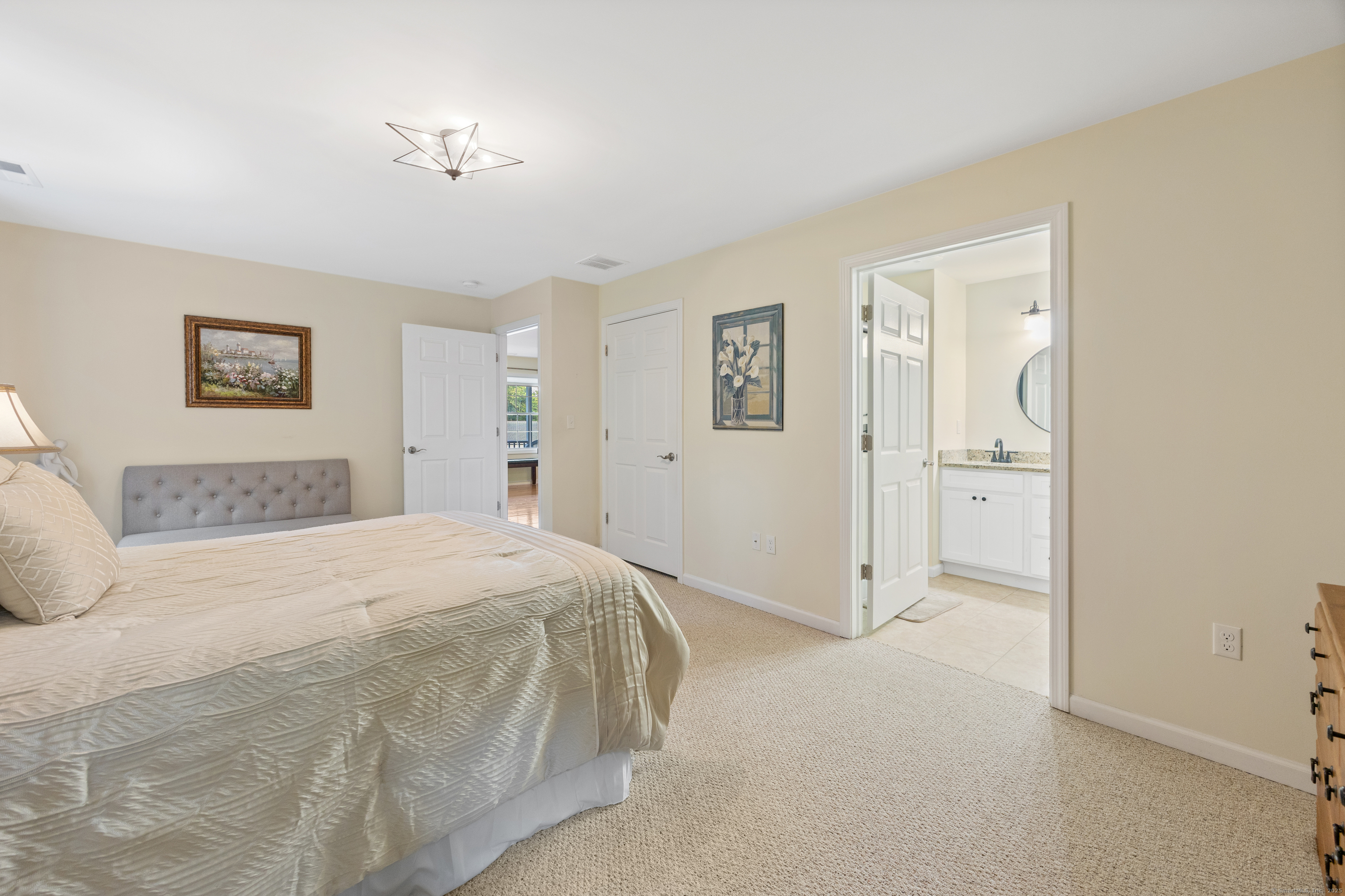 29 Hannah Way Harwinton, CT 06791 - Photo 18 of 34 a spacious bedroom with a bed and a painting on the wall