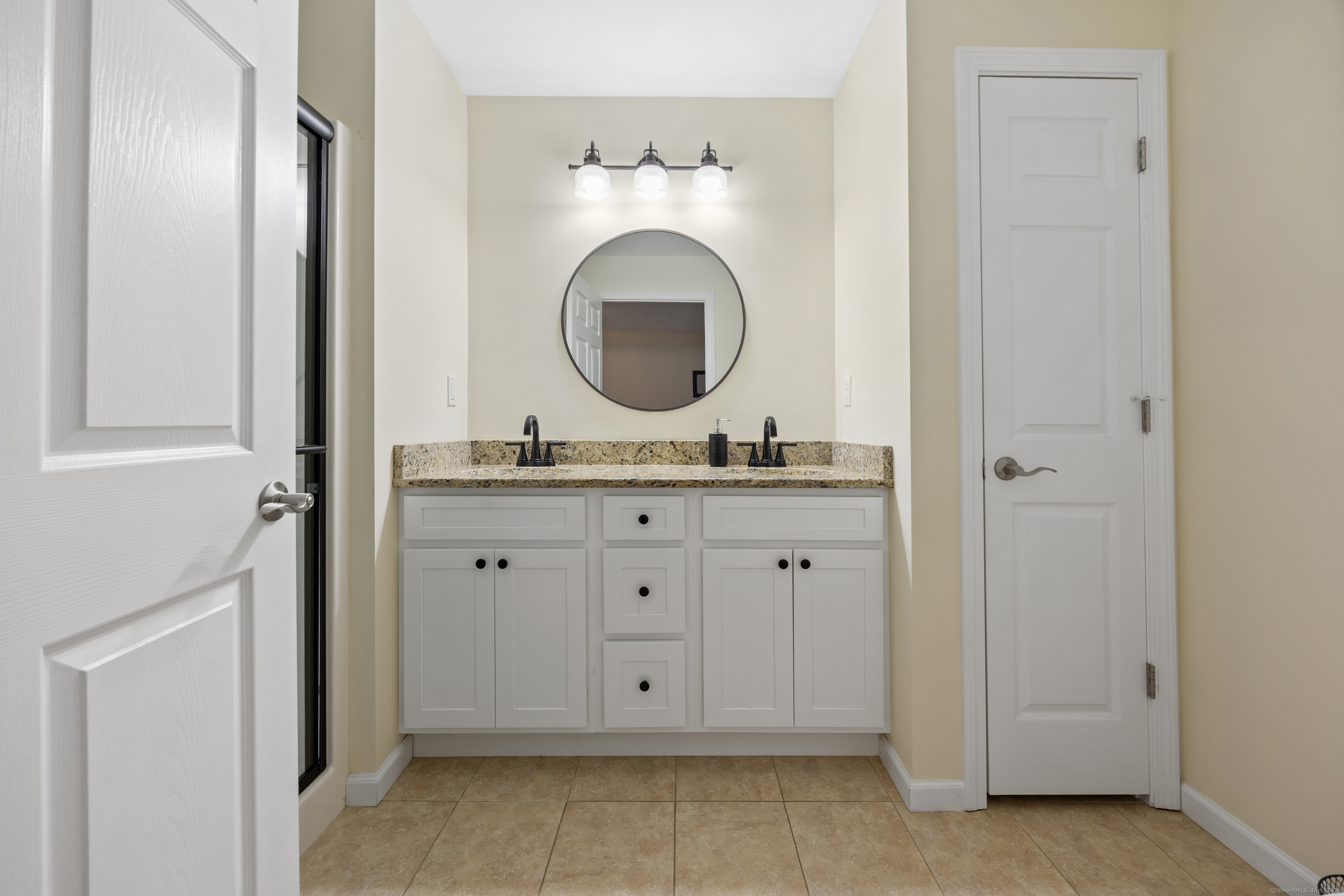 29 Hannah Way Harwinton, CT 06791 - Photo 19 of 34 a bathroom with a granite countertop sink and a mirror