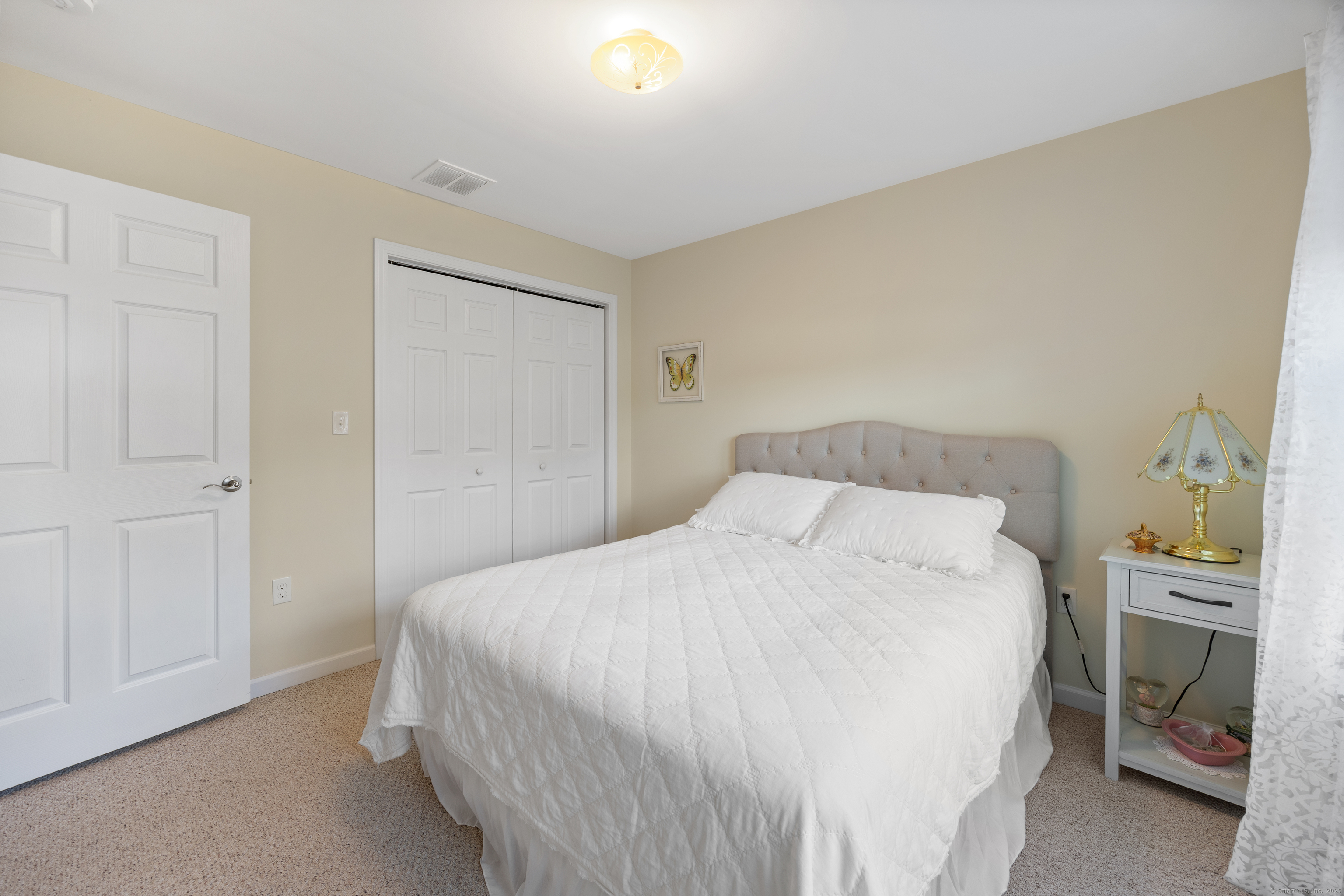 29 Hannah Way Harwinton, CT 06791 - Photo 22 of 34 a bedroom with a bed and a lamp