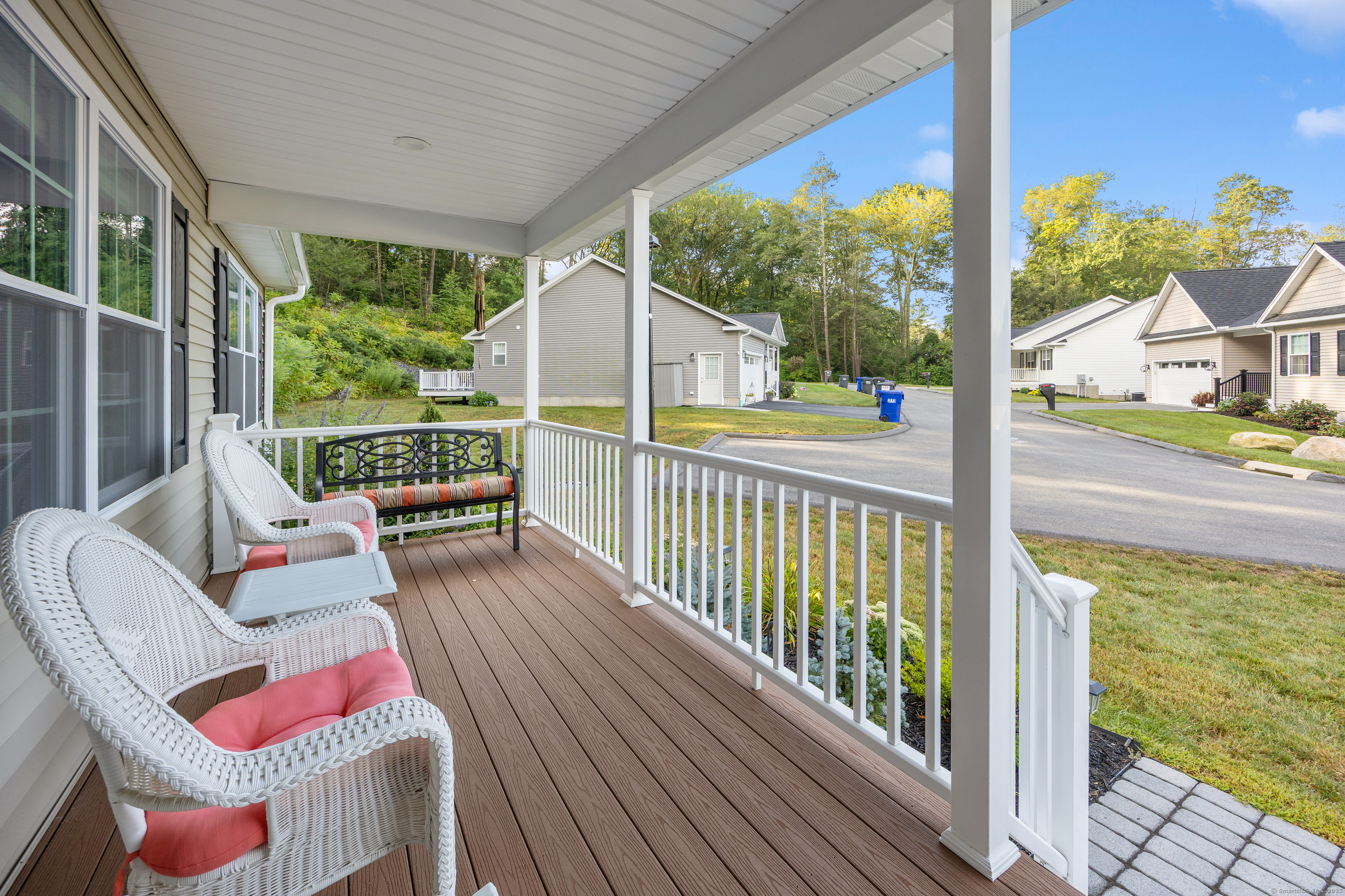29 Hannah Way Harwinton, CT 06791 - Photo 3 of 34 a view of a balcony with chair and wooden floor