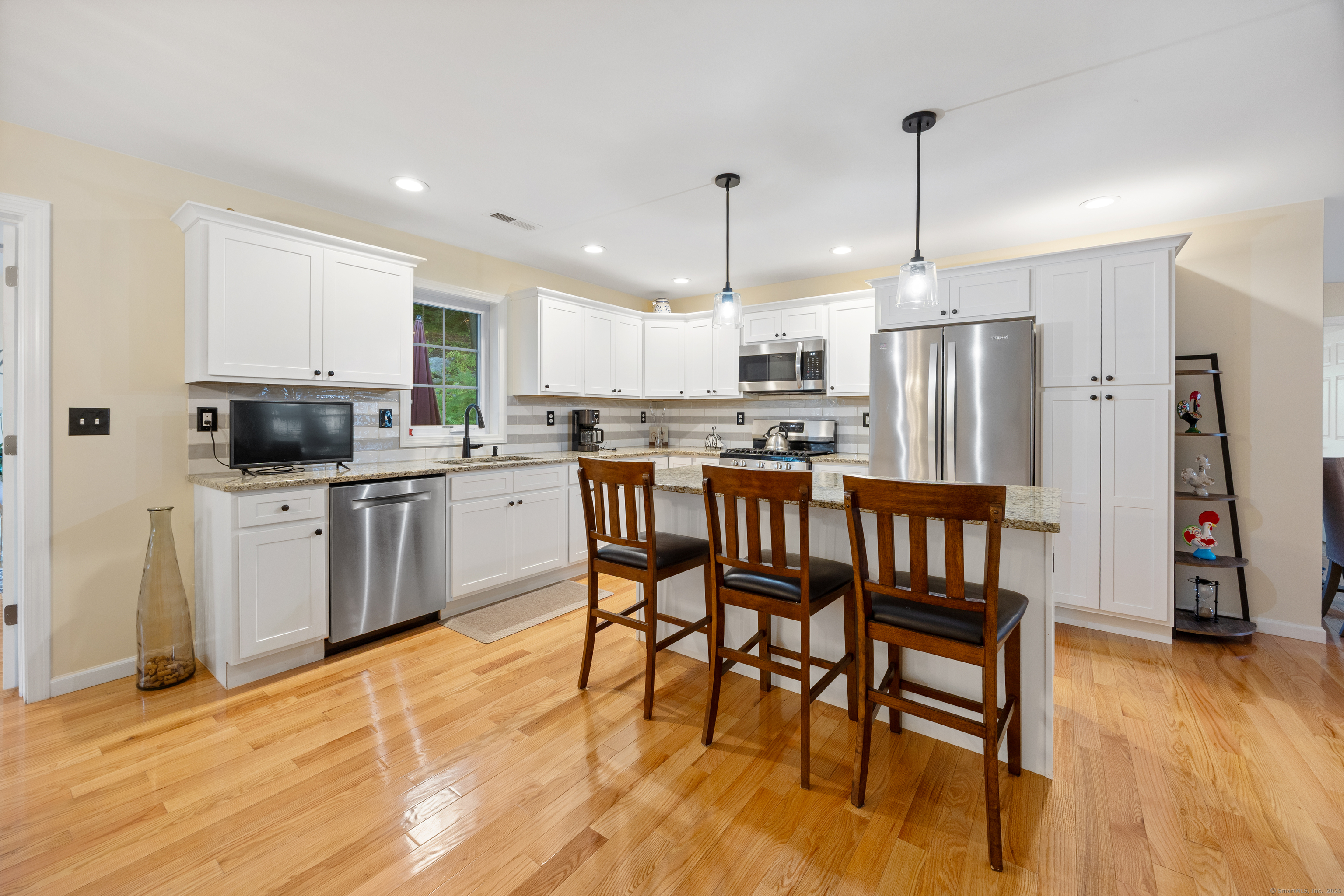 29 Hannah Way Harwinton, CT 06791 - Photo 9 of 34 a kitchen with stainless steel appliances kitchen island granite countertop a table chairs sink and cabinets