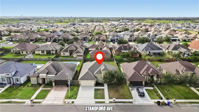 an aerial view of house with yard space and ocean view
