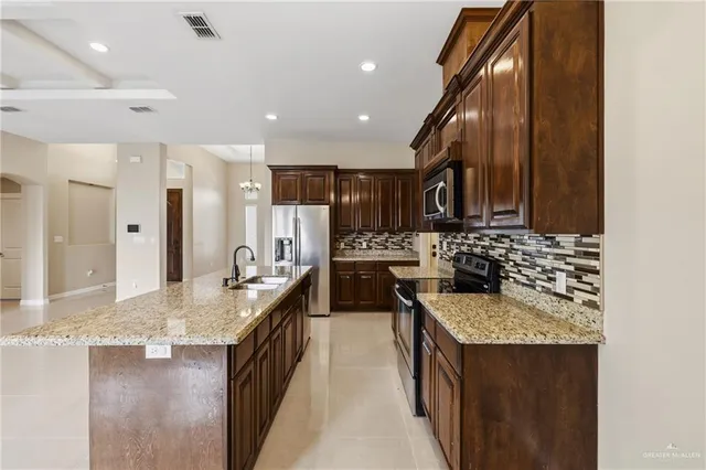 a kitchen with a stove sink and refrigerator