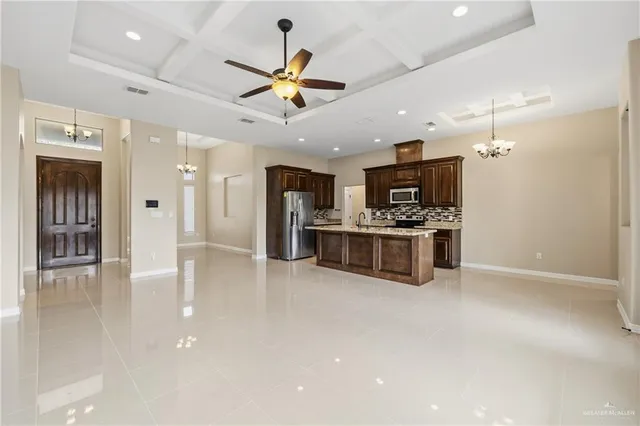 a kitchen with stainless steel appliances kitchen island a refrigerator sink and cabinets