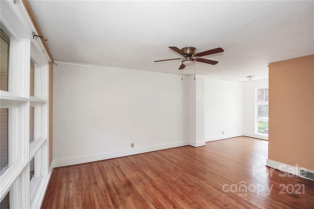 4230 Randolph Road Charlotte, NC 28211 - Photo 2 of 31 an empty room with wooden floor and ceiling fan