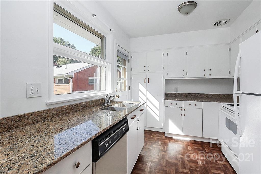 4230 Randolph Road Charlotte, NC 28211 - Photo 11 of 31 a kitchen with granite countertop a sink stove and cabinets