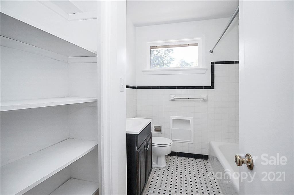 4230 Randolph Road Charlotte, NC 28211 - Photo 17 of 31 a bathroom with a toilet a sink a vanity and mirror