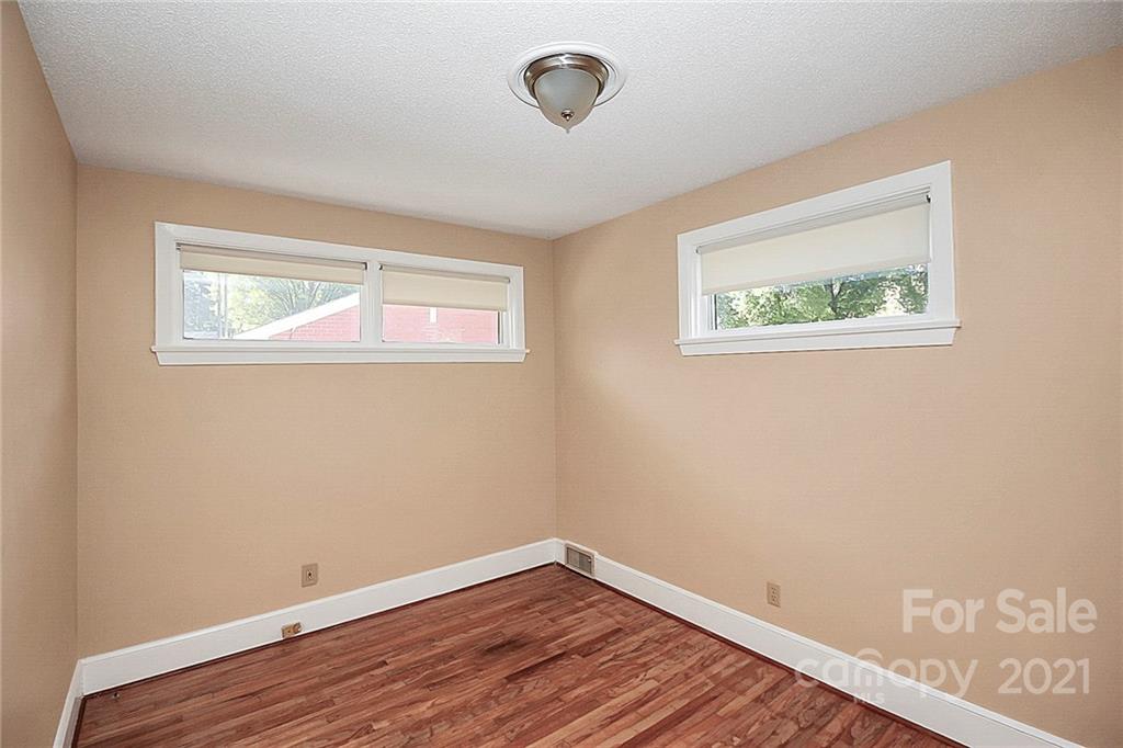 4230 Randolph Road Charlotte, NC 28211 - Photo 20 of 31 a view of an empty room with wooden floor and a window