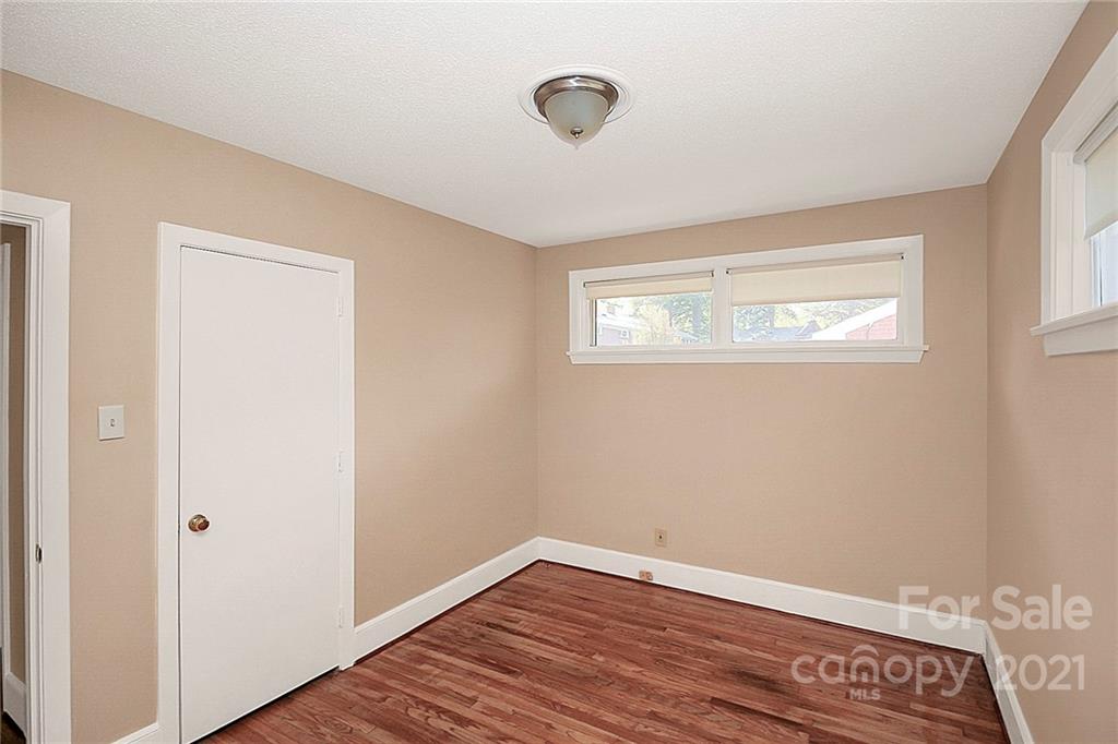 4230 Randolph Road Charlotte, NC 28211 - Photo 21 of 31 a view of an empty room with wooden floor and a window