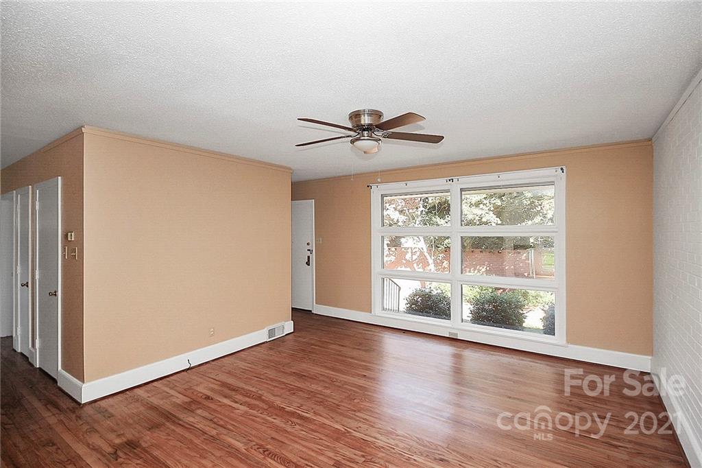 4230 Randolph Road Charlotte, NC 28211 - Photo 4 of 31 a view of an empty room with wooden floor and a window