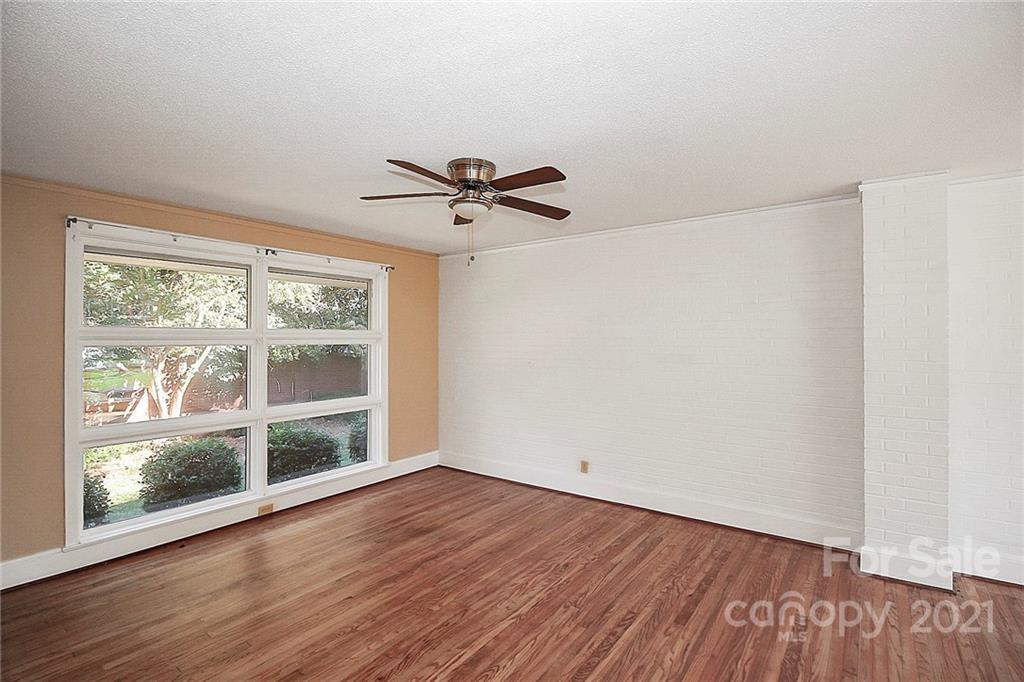 4230 Randolph Road Charlotte, NC 28211 - Photo 5 of 31 a view of wooden floor and a chandelier fan in a room