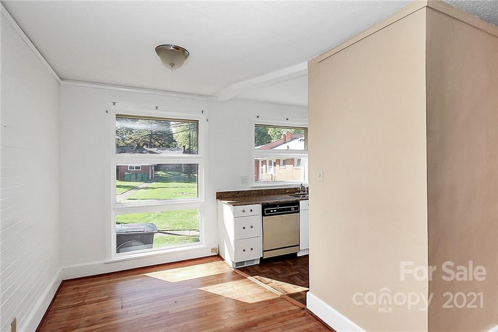 4230 Randolph Road Charlotte, NC 28211 - Photo 6 of 31 a kitchen with granite countertop a stove and a wooden floor