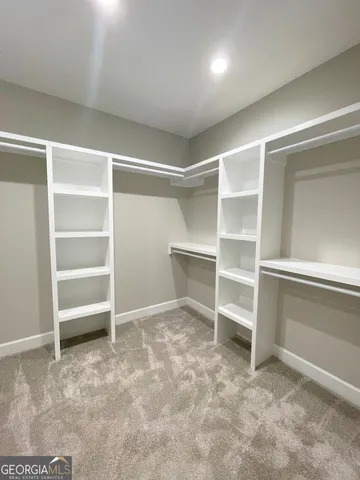 a view of an empty room with a closet