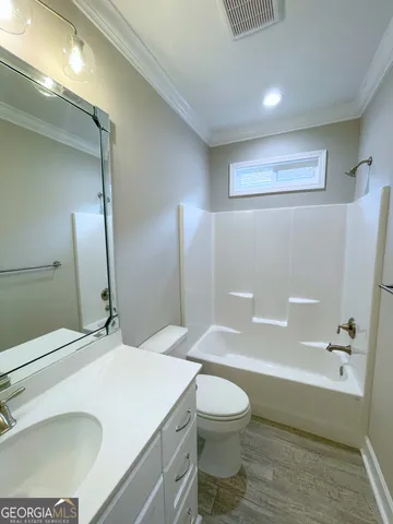 a bathroom with a sink a toilet and a bathtub