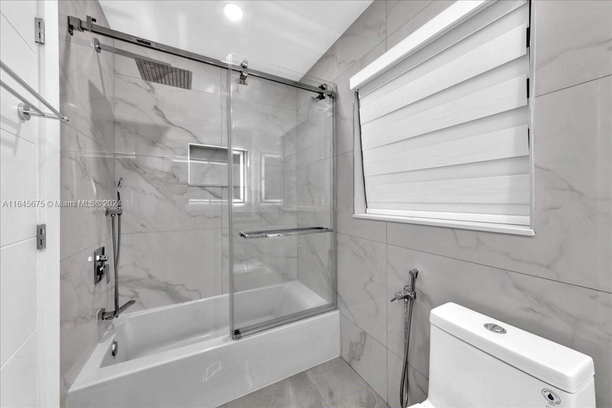 2373 Southwest 177th Terrace Miramar, FL 33029 - Photo 12 of 79 a bathroom with a shower and bathtub
