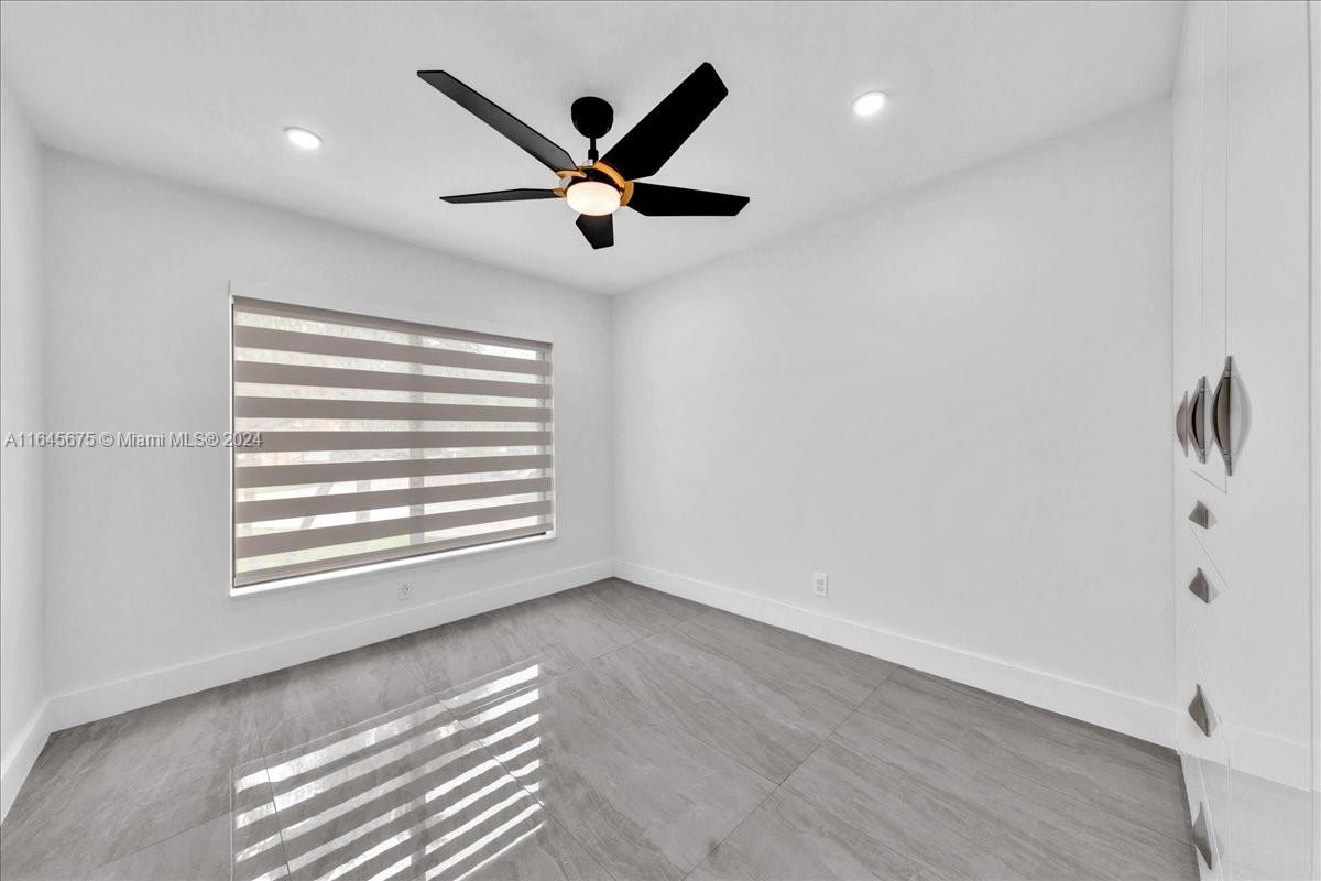 2373 Southwest 177th Terrace Miramar, FL 33029 - Photo 13 of 79 a view of a livingroom with a ceiling fan and wooden floor