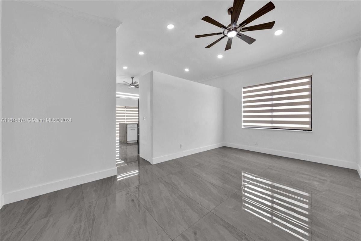 2373 Southwest 177th Terrace Miramar, FL 33029 - Photo 19 of 79 an empty room with wooden floor and windows