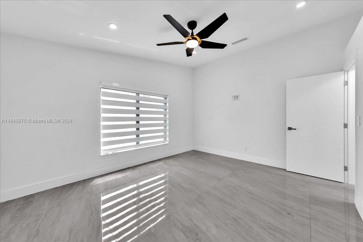 2373 Southwest 177th Terrace Miramar, FL 33029 - Photo 28 of 79 wooden floor in an empty room with a window