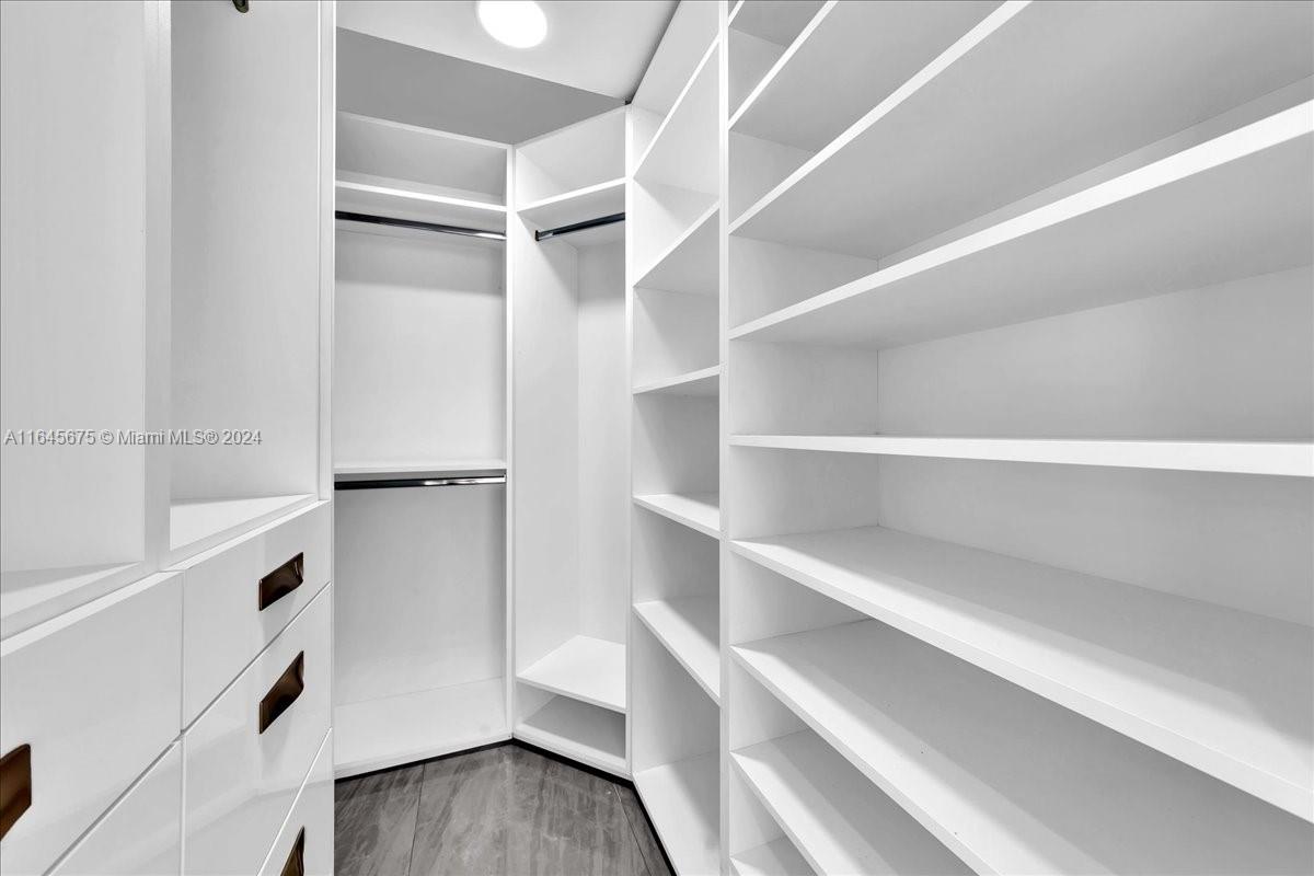 2373 Southwest 177th Terrace Miramar, FL 33029 - Photo 31 of 79 a view of walk in closet with empty racks