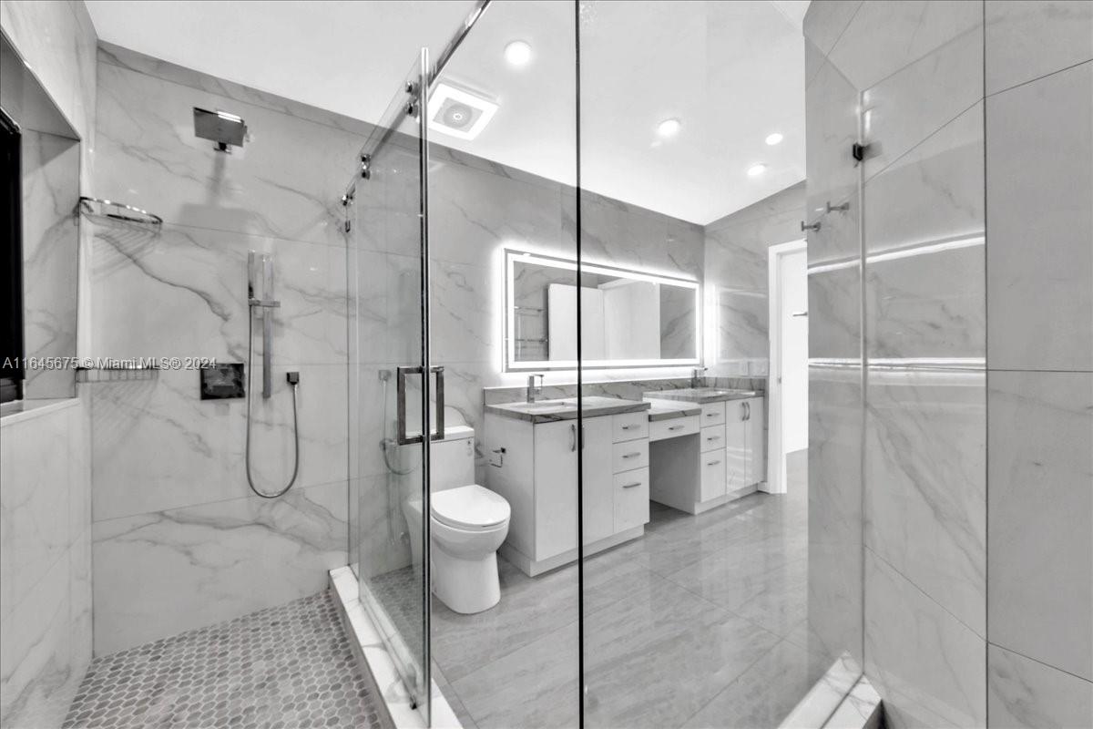 2373 Southwest 177th Terrace Miramar, FL 33029 - Photo 36 of 79 a bathroom with a granite countertop sink toilet and shower